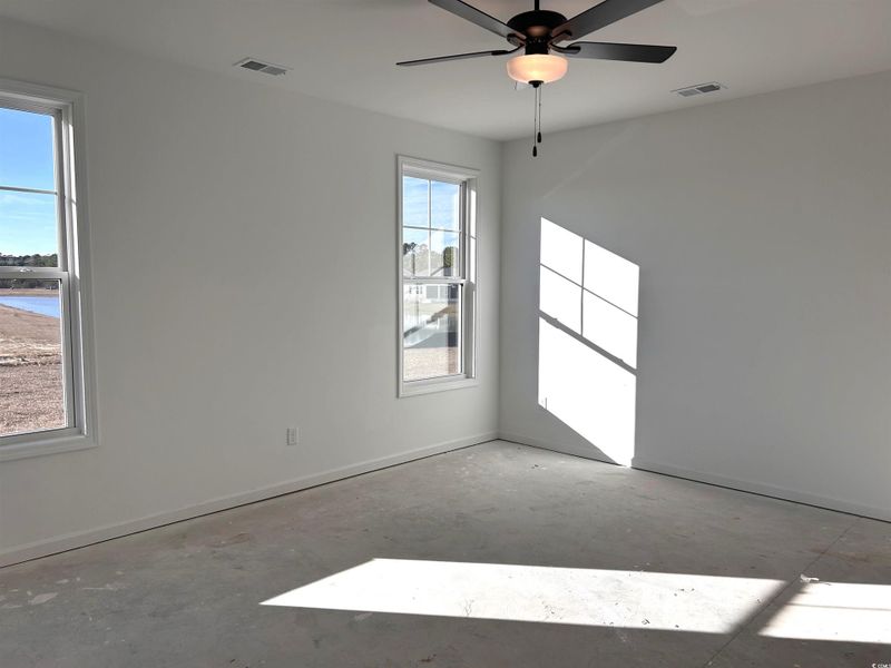 Spare room with concrete flooring and ceiling fan