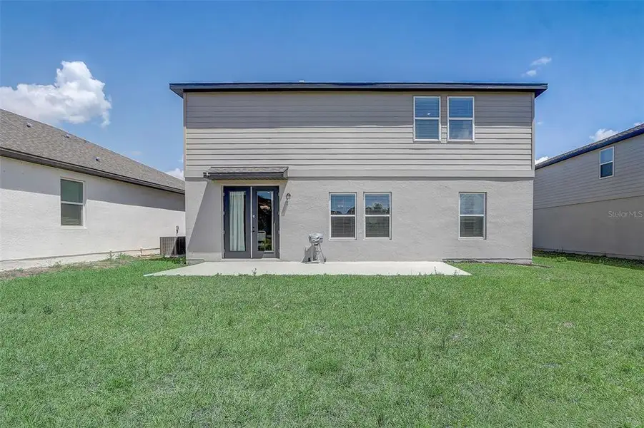 Exterior details and patio area of a home in Glen at West Haven, Davenport (Image 29).