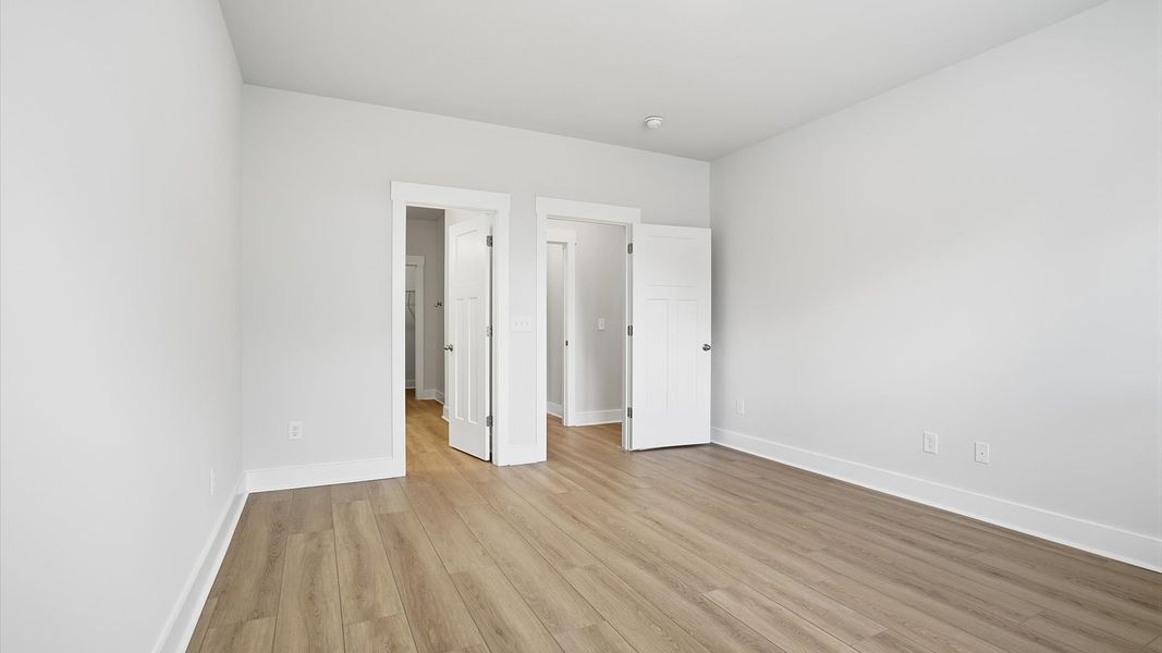 Spacious and serene primary suite with thoughtful design in a desirable DRB Homes community