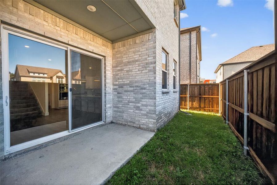 Fenced backyard with a patio area Fenced backyard with a patio area