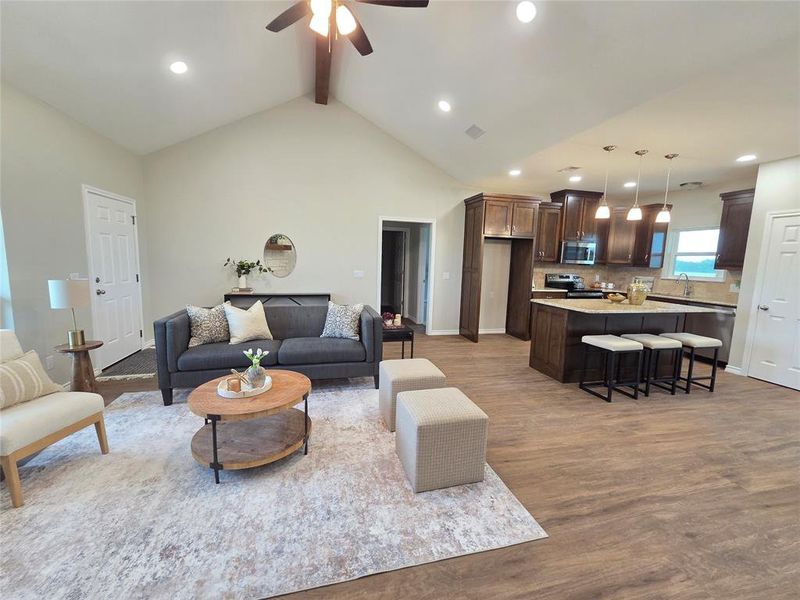 Living area featuring wood finished floors, a ceiling fan, and recessed lighting Living area featuring wood finished floors, a ceiling fan, and recessed lighting