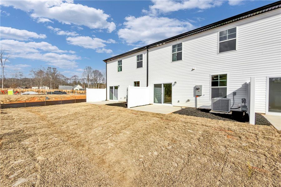 This new construction features a private patio and This new construction features a private patio and