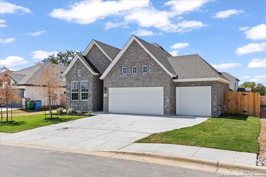 Front exterior of a new home in Village at Three Oaks, Seguin, TX, highlighting curb appeal (Image 13).