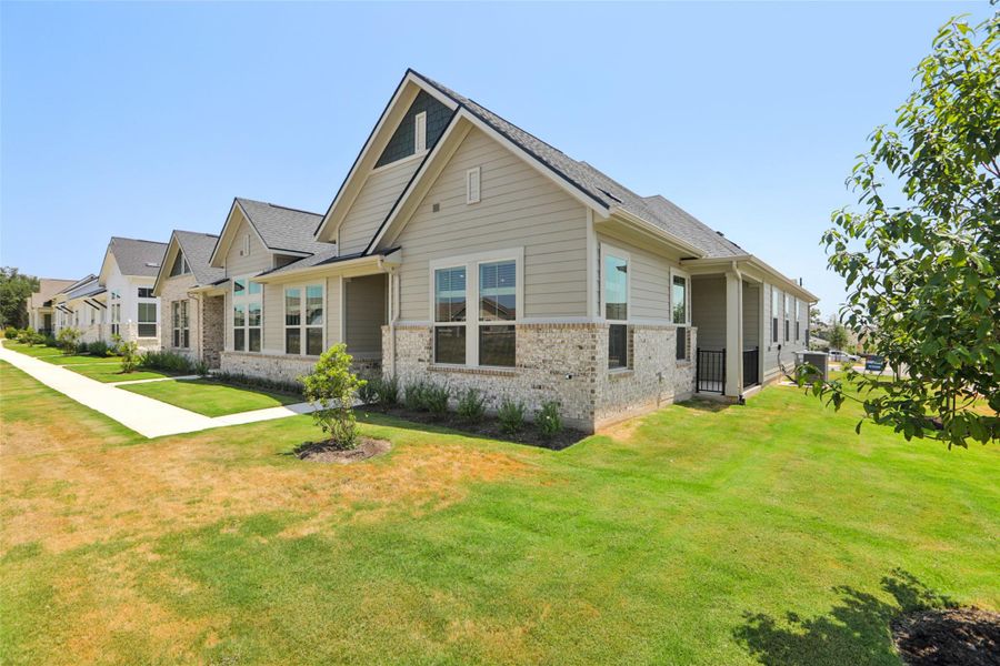 View of front of house with brick siding, a front yard, and a residential view View of front of house with brick siding, a front yard, and a residential view