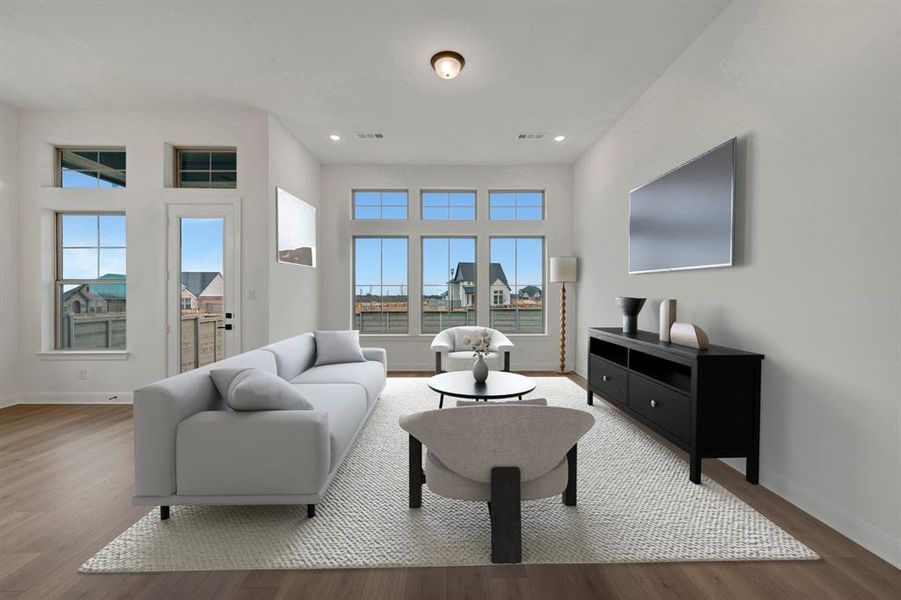 Living room with wood finished floors and recessed lighting
