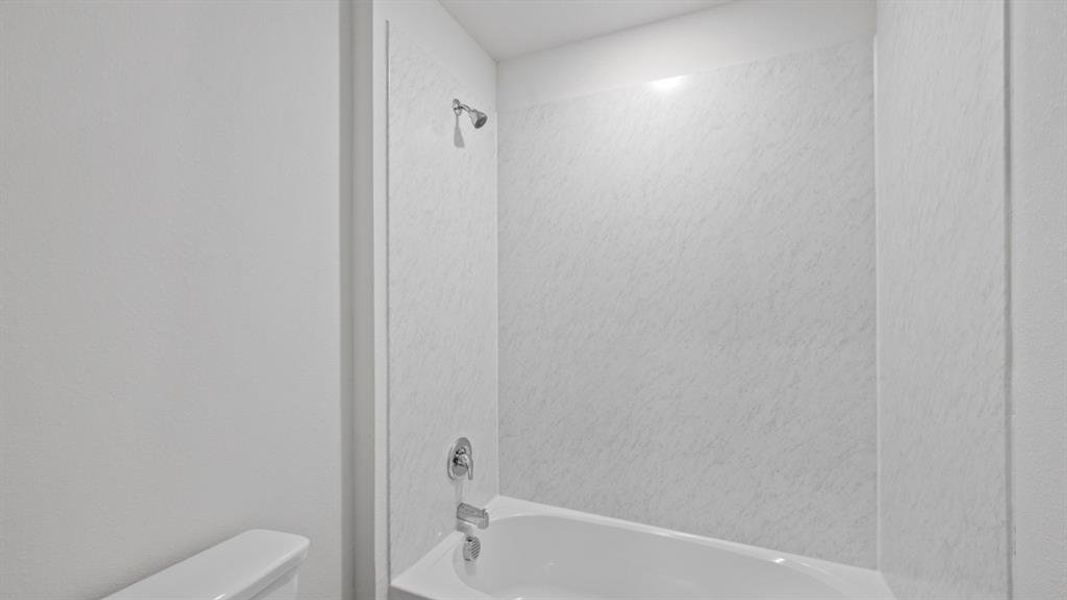 Full bath featuring shower / tub combination and toilet