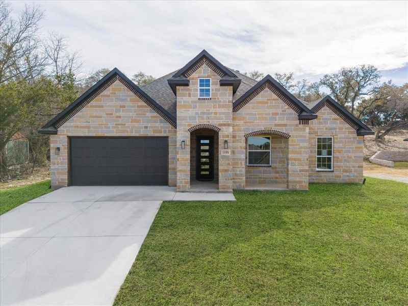 View of front facade with a front yard and a garage