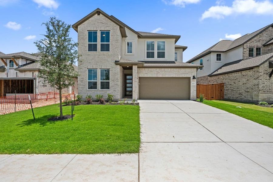 Front exterior of a new home in Lariat, Liberty Hill, TX, highlighting curb appeal (Image 1). Front exterior of a new home in Lariat, Liberty Hill, TX, highlighting curb appeal (Image 1).