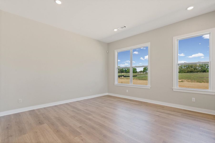 Spare room featuring light wood finished floors and recessed lighting