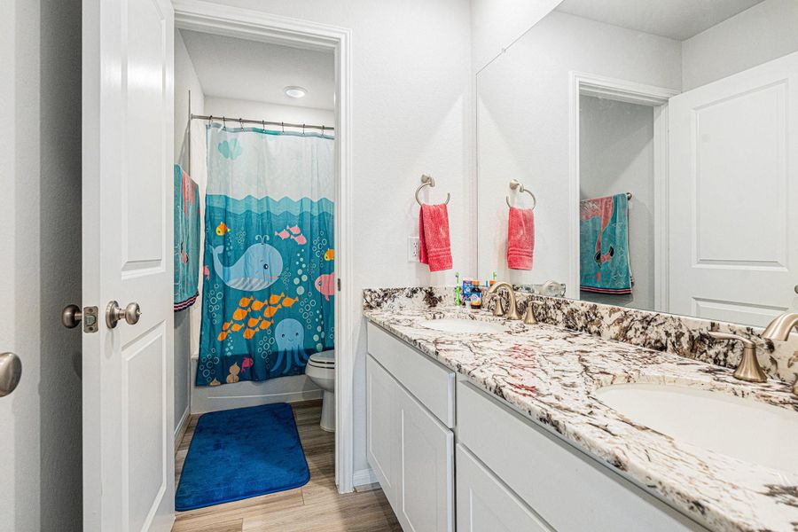 The secondary bathroom upstairs has been upgraded with double sinks and tile tub surround. The secondary bathroom upstairs has been upgraded with double sinks and tile tub surround.