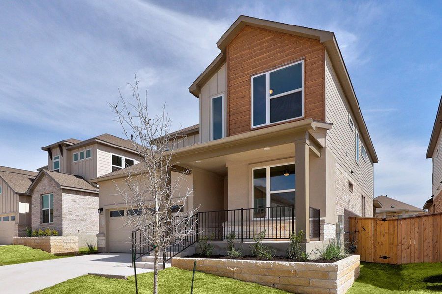 Front exterior of a new home in University Heights, Round Rock, TX, highlighting curb appeal (Image 21).