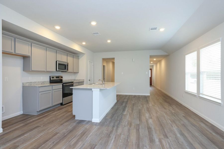 Canned lighting assists with meal prep keeping the Kitchen and Dining area light and bright.