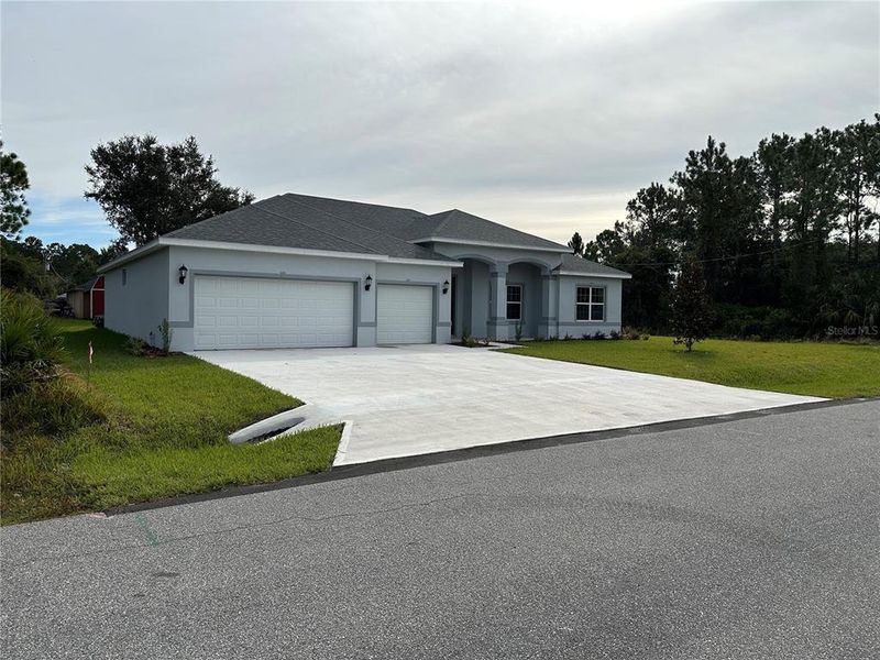 Front exterior of a new home in , Palm Coast, FL, highlighting curb appeal (Image 2).