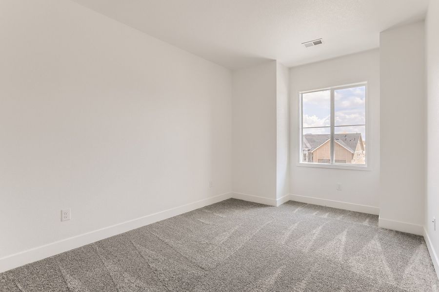 Upstairs secondary bedroom in Cornell II plan at The Outlook at Southshore by Century Communities