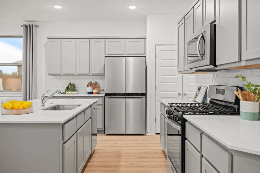 Kitchen in the Oak home plan by Trophy Signature Homes – REPRESENTATIVE PHOTO