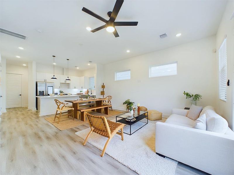 open concept living/dining/kitchen area on the first floor including Bifold Doors to walk out into backyard.