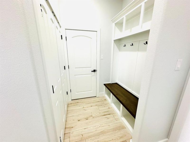 Mudroom with light hardwood / wood-style flooring