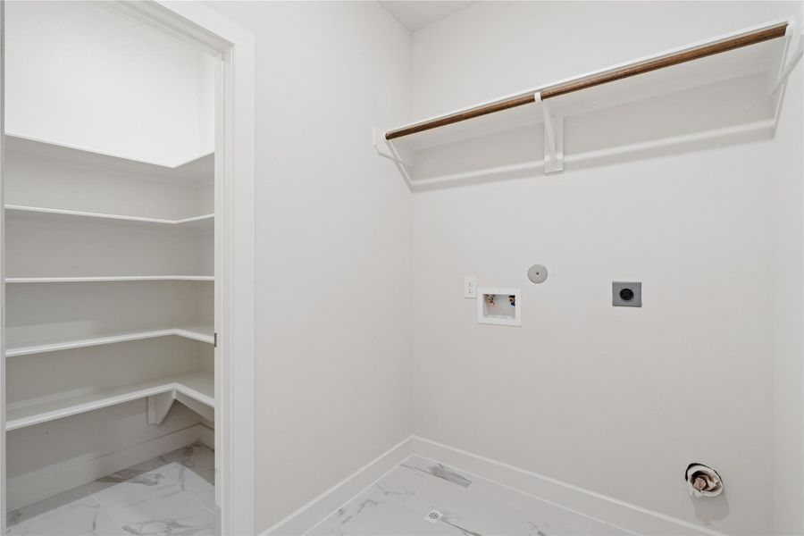 Dedicated upstairs laundry room with built-in shelving and full-size washer/dryer hookups, keeping laundry off the main floor entirely. Dedicated upstairs laundry room with built-in shelving and full-size washer/dryer hookups, keeping laundry off the main floor entirely.