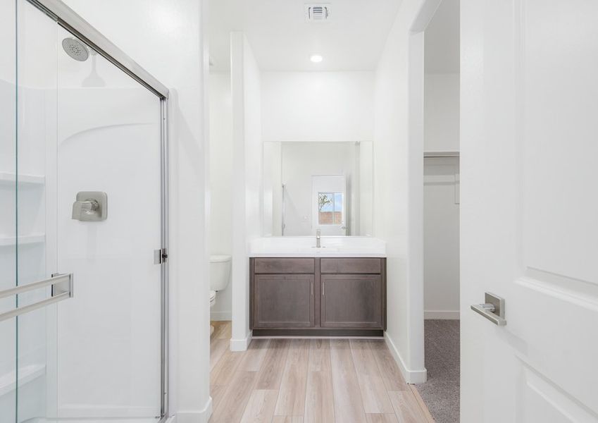 The master bathroom has a beautiful glass-enclosed shower.