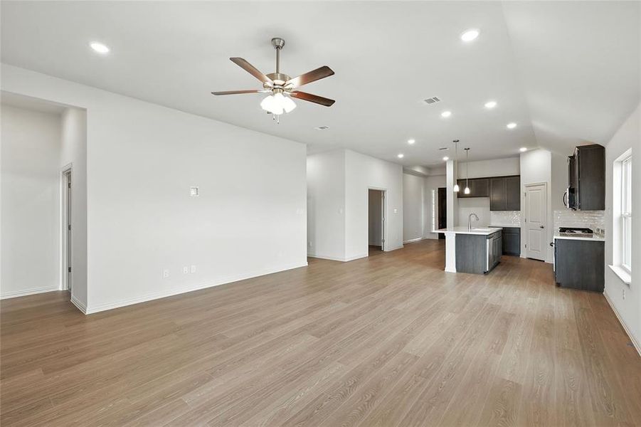 Unfurnished living room featuring light wood finished floors, recessed lighting, and a ceiling fan Unfurnished living room featuring light wood finished floors, recessed lighting, and a ceiling fan