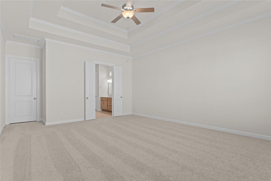 This additional angle highlights the openness of the primary bedroom, with soft neutral tones and thoughtful design that allow for flexible furniture placement and a truly restful setting.