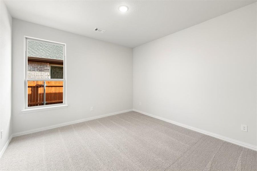 Carpeted spare room with baseboards