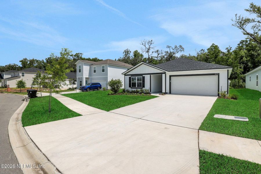 Front exterior of a new home in Wilford Oaks, Orange Park, FL, highlighting curb appeal (Image 24). Front exterior of a new home in Wilford Oaks, Orange Park, FL, highlighting curb appeal (Image 24).