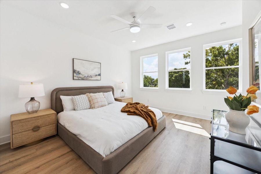 The primary suite also has abundant light and tree top views. This is a king bed with generous side tables. The primary suite also has abundant light and tree top views. This is a king bed with generous side tables.
