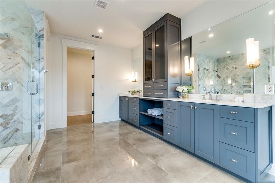 Bathroom featuring vanity and a shower with shower door