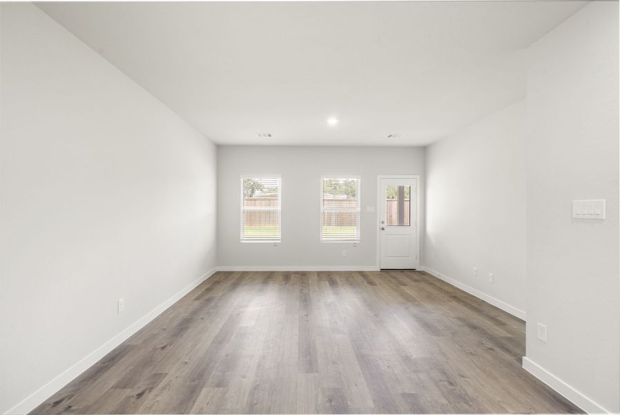 A room with a wood floor and white walls.