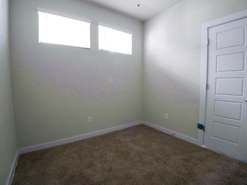 Unfurnished room featuring dark colored carpet and baseboards Unfurnished room featuring dark colored carpet and baseboards