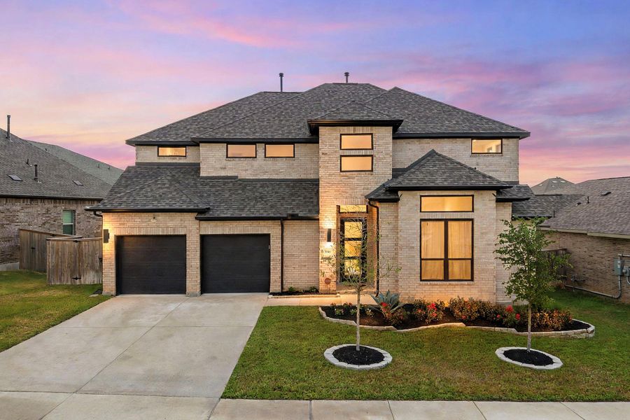A striking modern residence boasts an inviting entry, two-car garage, and thoughtfully designed landscaping. A striking modern residence boasts an inviting entry, two-car garage, and thoughtfully designed landscaping.