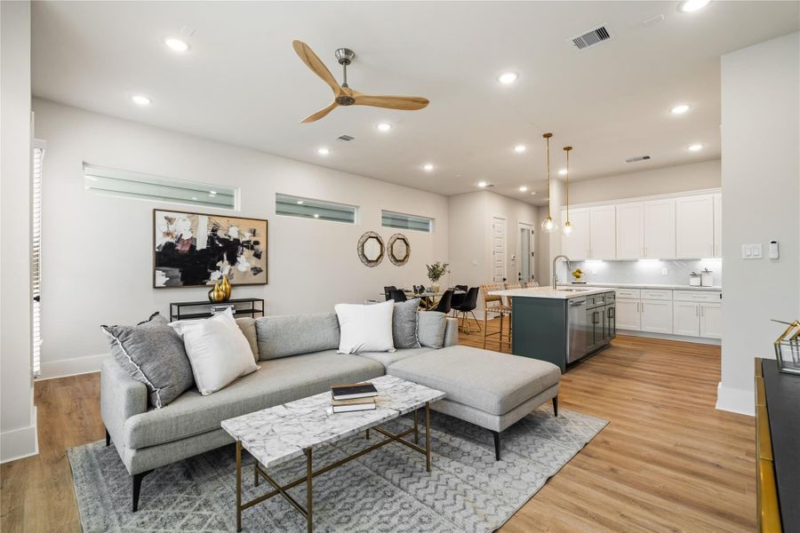 Volume and light define the main living space, where elevated ceilings and expansive windows enhance the open layout. A dedicated dining area introduces structure, creating a balanced flow between gathering and everyday living. Volume and light define the main living space, where elevated ceilings and expansive windows enhance the open layout. A dedicated dining area introduces structure, creating a balanced flow between gathering and everyday living.