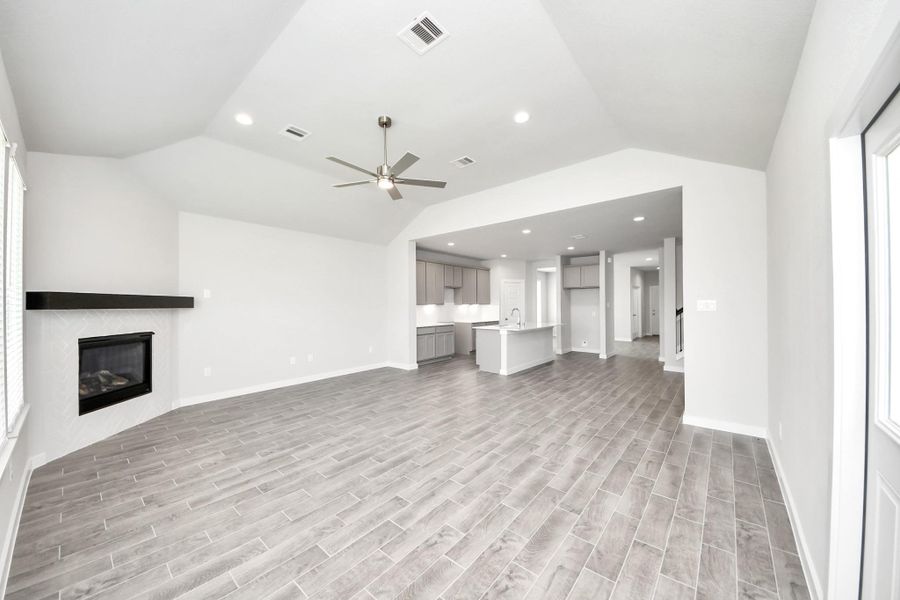 Welcome family and guests to your charming living room! With its high ceilings, recessed lighting, ceiling fan, custom paint, beautiful flooring, and large windows that let in abundant natural light, this room is perfect for gatherings. Welcome family and guests to your charming living room! With its high ceilings, recessed lighting, ceiling fan, custom paint, beautiful flooring, and large windows that let in abundant natural light, this room is perfect for gatherings.