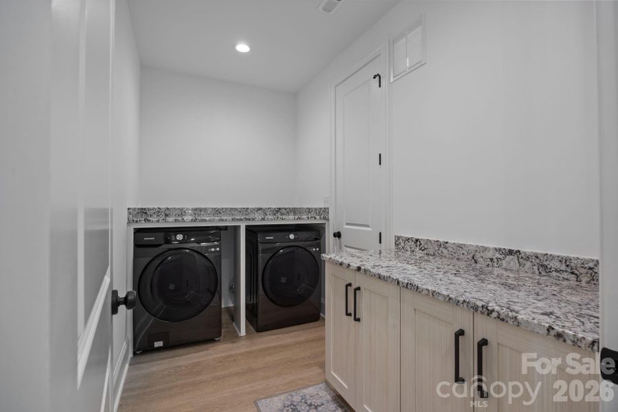 Access the laundry from the hallway or primary closet