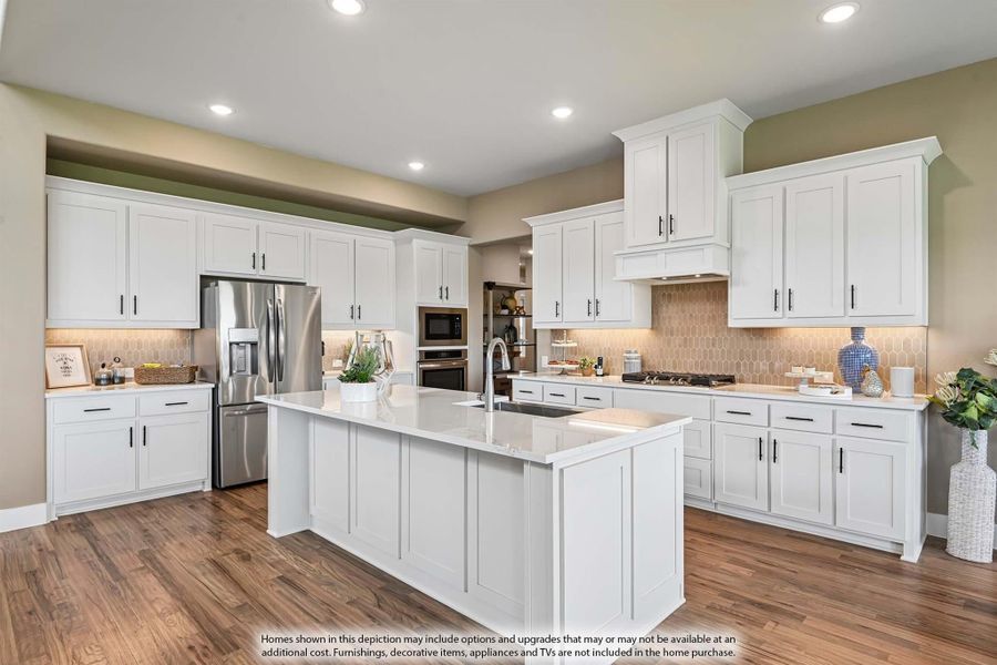 Kitchen with white shaker cabinets, large center island with sink, stainless steel appliances, and hardwood floors Kitchen with white shaker cabinets, large center island with sink, stainless steel appliances, and hardwood floors