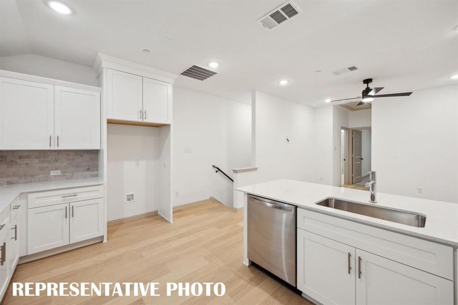 You'll find designer chosen finishes like shaker style cabinets, gorgeous flooring, stainless appliances and beautiful counter tops in our Elizabeth plan!  REPRESENTATIVE PHOTO