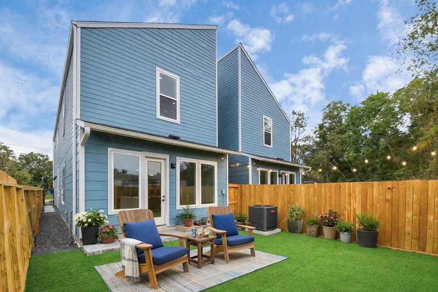 Private backyard with cozy seating area and low-maintenance turf. Perfect outdoor space for relaxing or entertaining.