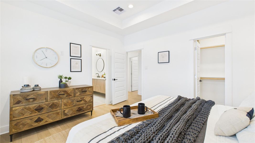 Bright and spacious, this spacious primary bedroom is filled with natural light and features two generous closets, his and hers, along with a well-sized primary bathroom, creating a bright and comfortable retreat with ample storage and luxury.