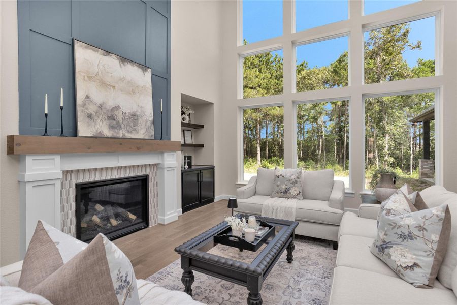 The fireplace is framed by a custom wood surround and a bold blue feature wall (Paint color: Wallstreet) that extends to the ceiling creating a striking focal point. A natural cut, solid wood mantle adds warmth and contrast, tying the entire design together with timeless character.