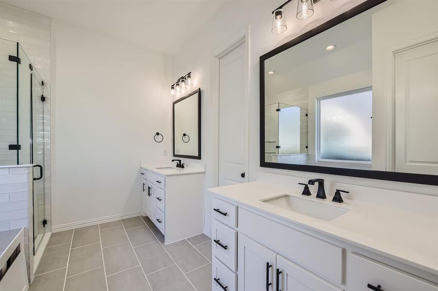 Bathroom with vanity, tile patterned floors, and walk in shower