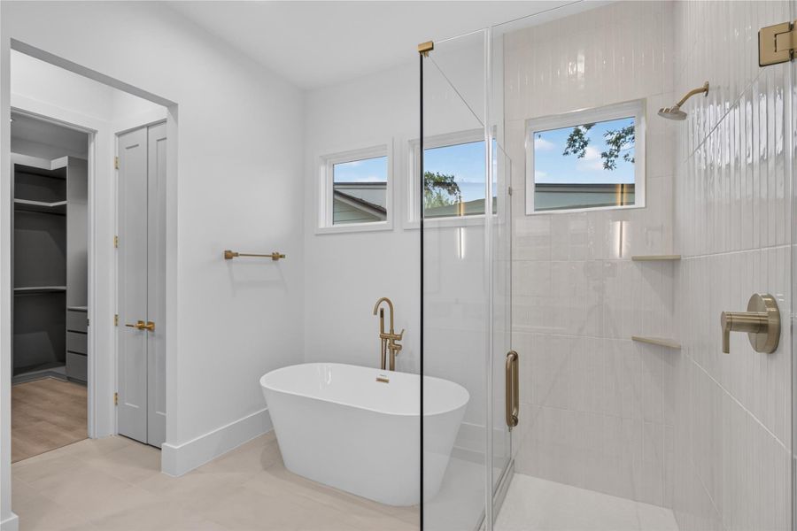Inspired by luxury spas, the primary bath features designer finishes, elegant fixtures, and a tranquil atmosphere perfect for unwinding. Inspired by luxury spas, the primary bath features designer finishes, elegant fixtures, and a tranquil atmosphere perfect for unwinding.