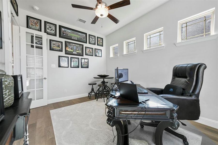 Office featuring ceiling fan and dark wood-type flooring