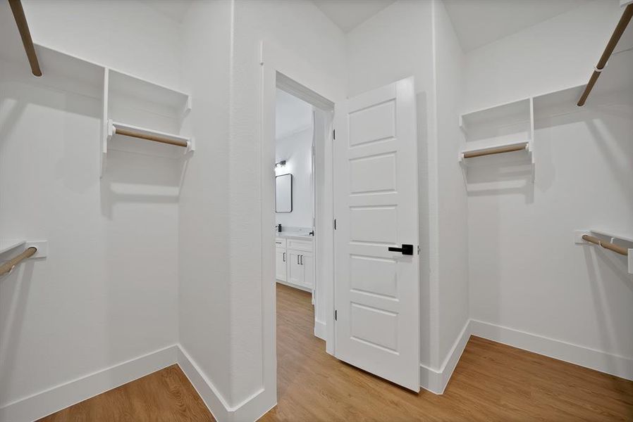 Walk in closet featuring light wood-style floors