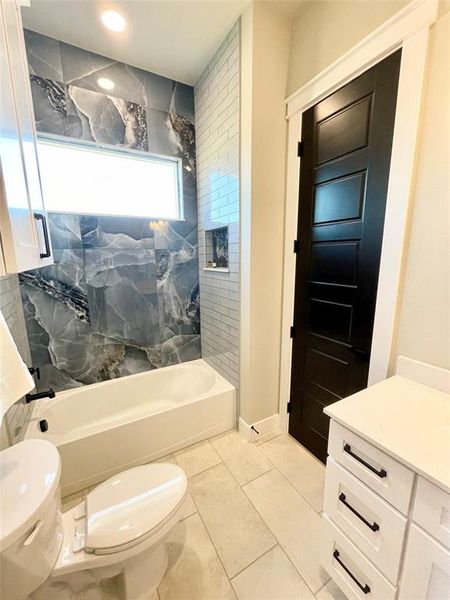 Thrid bath featuring vanity and shower / washtub combination