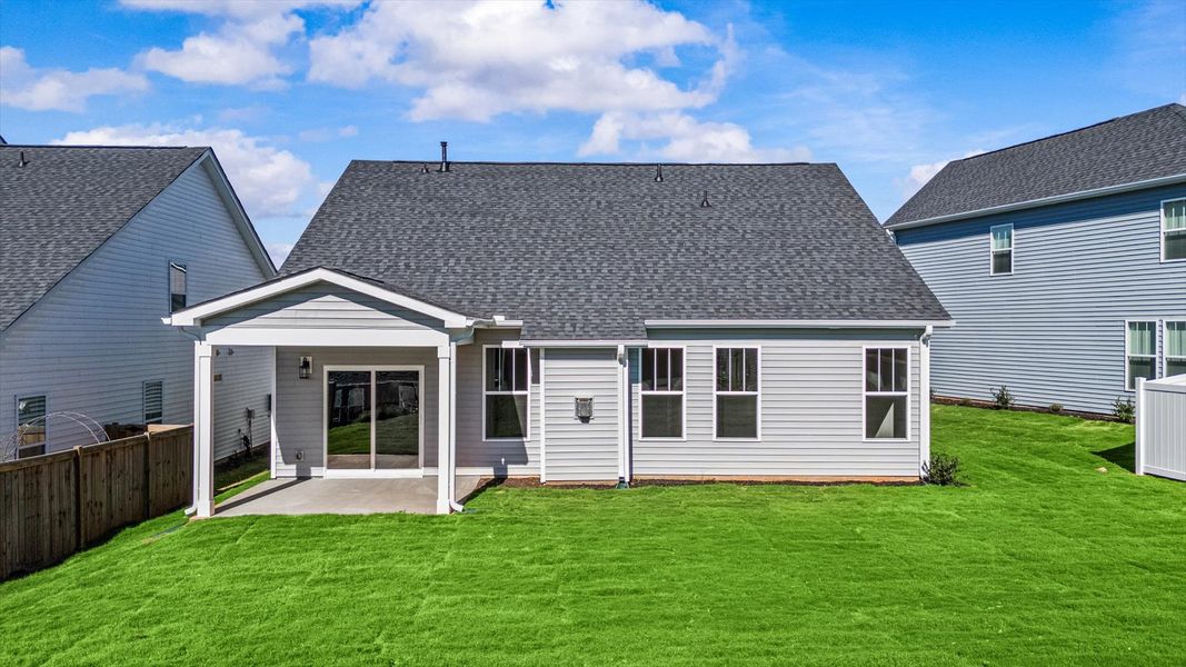 Vibrant rear outdoor space featuring a covered porch and exceptional craftsmanship