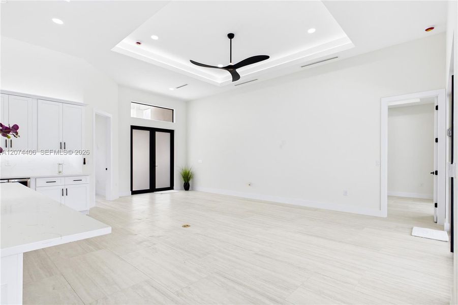 OPEN LIVING AREA showcases a dramatic DOUBLE-TRAY CEILING w/ LED ACCENT LIGHTING, sleek LINEAR A/C DIFFUSERS & contemporary statement ceiling fan. OPEN LIVING AREA showcases a dramatic DOUBLE-TRAY CEILING w/ LED ACCENT LIGHTING, sleek LINEAR A/C DIFFUSERS & contemporary statement ceiling fan.