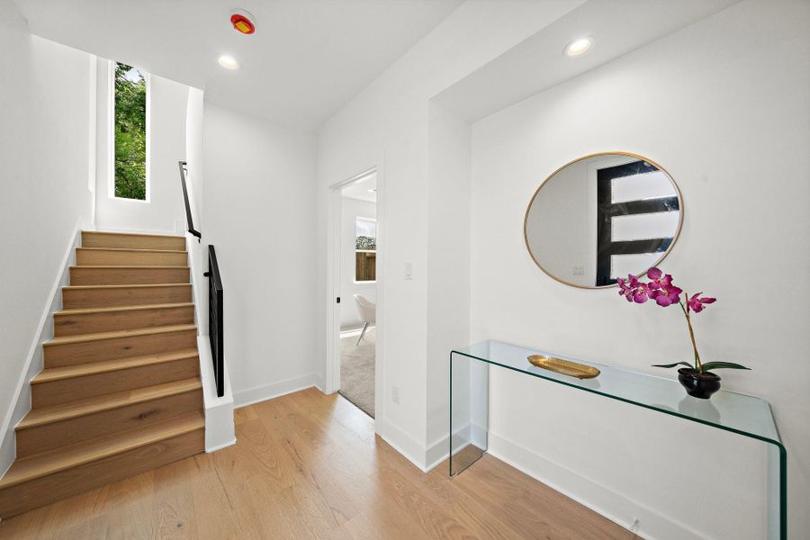 Step into a welcoming entryway that sets the tone for the rest of the home with its clean lines, abundant natural light, and inviting atmosphere. The space features a modern front door, tasteful flooring, and a seamless flow into the house—offering a perfect first impression.