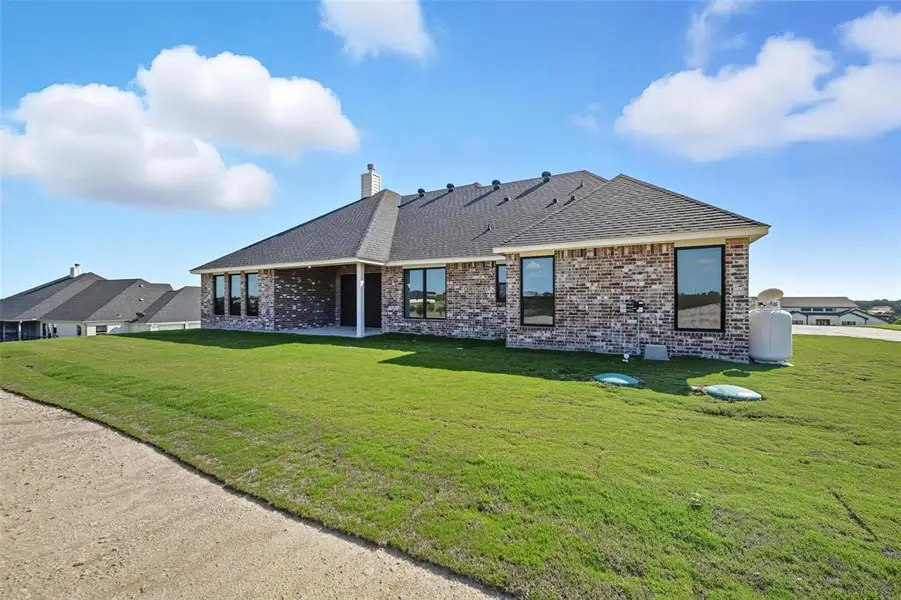 Front exterior of a new home in Eagles Bluff, Willow Park, TX, highlighting curb appeal (Image 2).