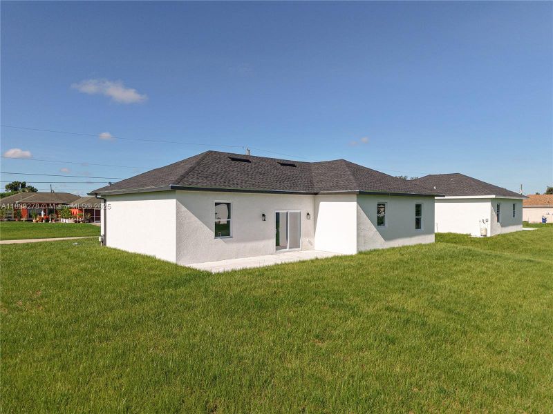 Front exterior of a new home in , Lehigh Acres, FL, highlighting curb appeal (Image 27).